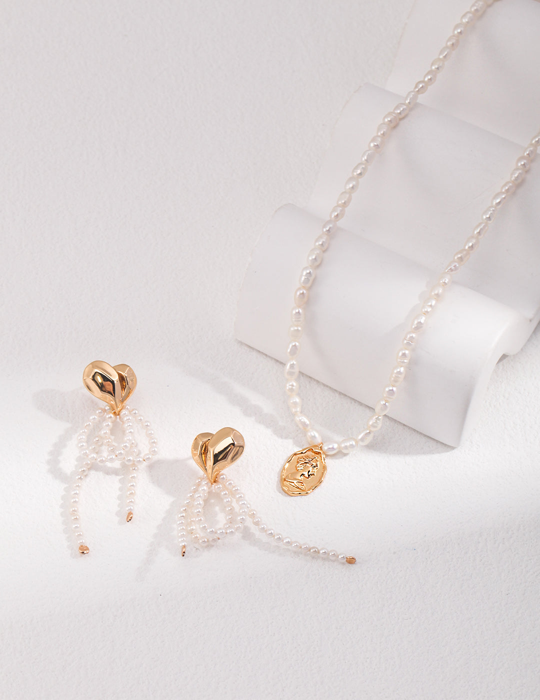 Golden Bust Pendant on Rice Pearl Necklace